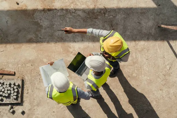 birds eye view of three people in high vis and hard hats